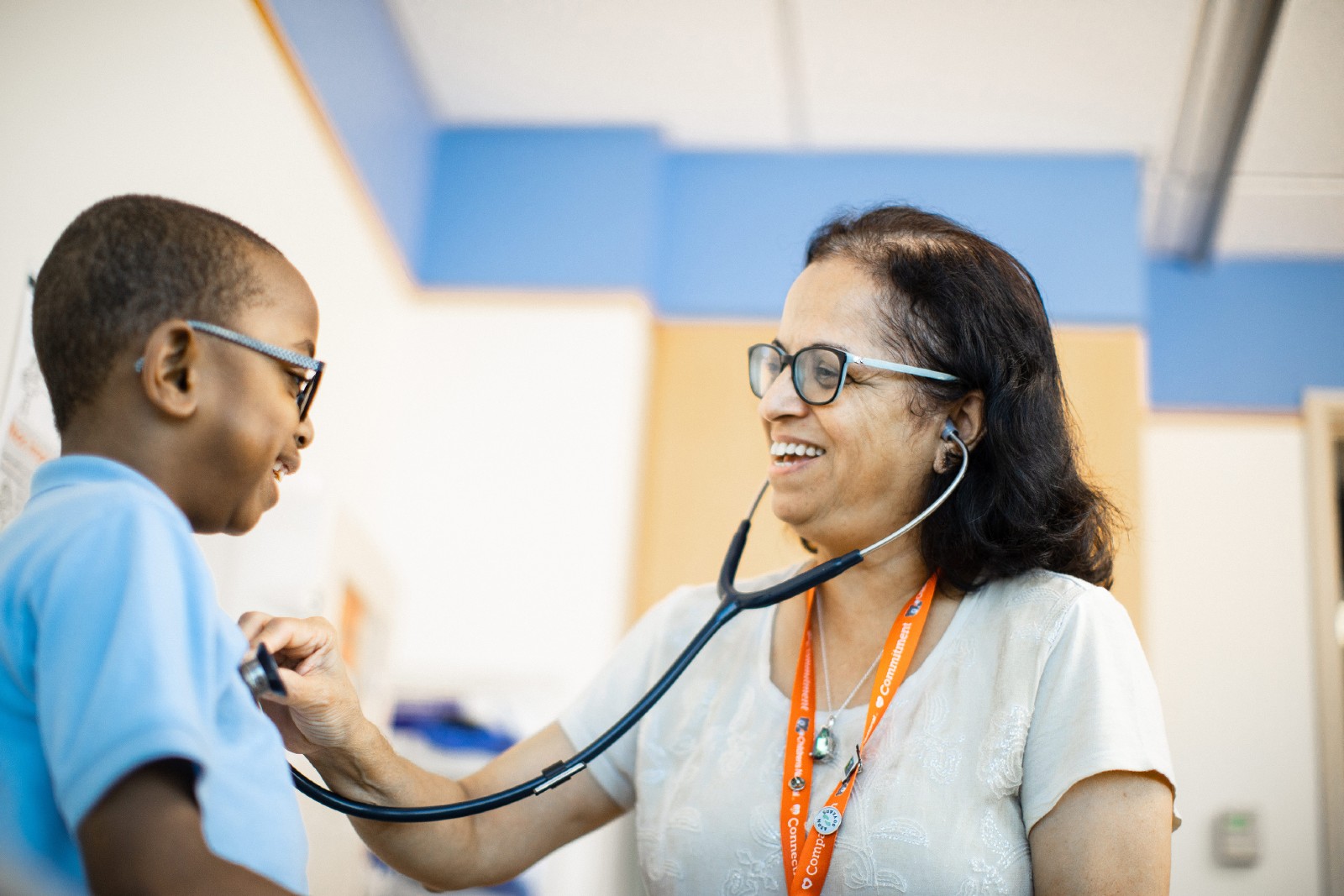 Nephrology provider using stethoscope on patient.